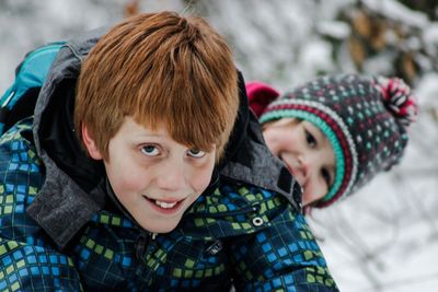 Close-up portrait of smiling girl in snow