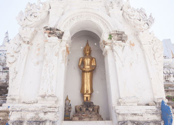 Low angle view of statue against building