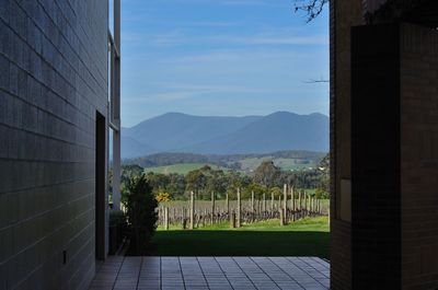 Scenic view of mountains against sky seen through window