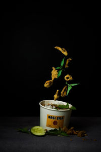 Close-up of fruits on table against black background