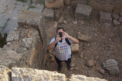 High angle view of man photographing at old ruin
