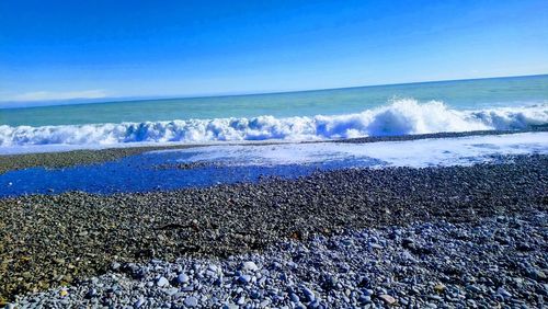 Scenic view of sea against clear blue sky