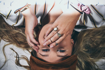 Close-up portrait of woman with hands