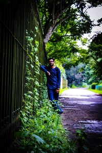 Full length of young man standing on tree