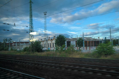 Railroad tracks against cloudy sky