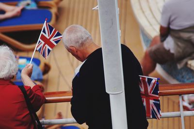 Senior people with british flags standing on ship