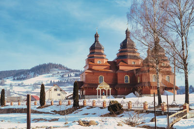 Small village church with cemetery in slavske located on the west of ukraine with mountains