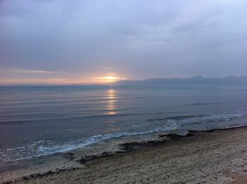 Scenic view of sea against sky at sunset