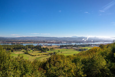 High angle view of field against blue sky