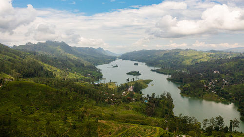 Aerial drone of hills with tea plantations around the lake in the mountains. maskeliya