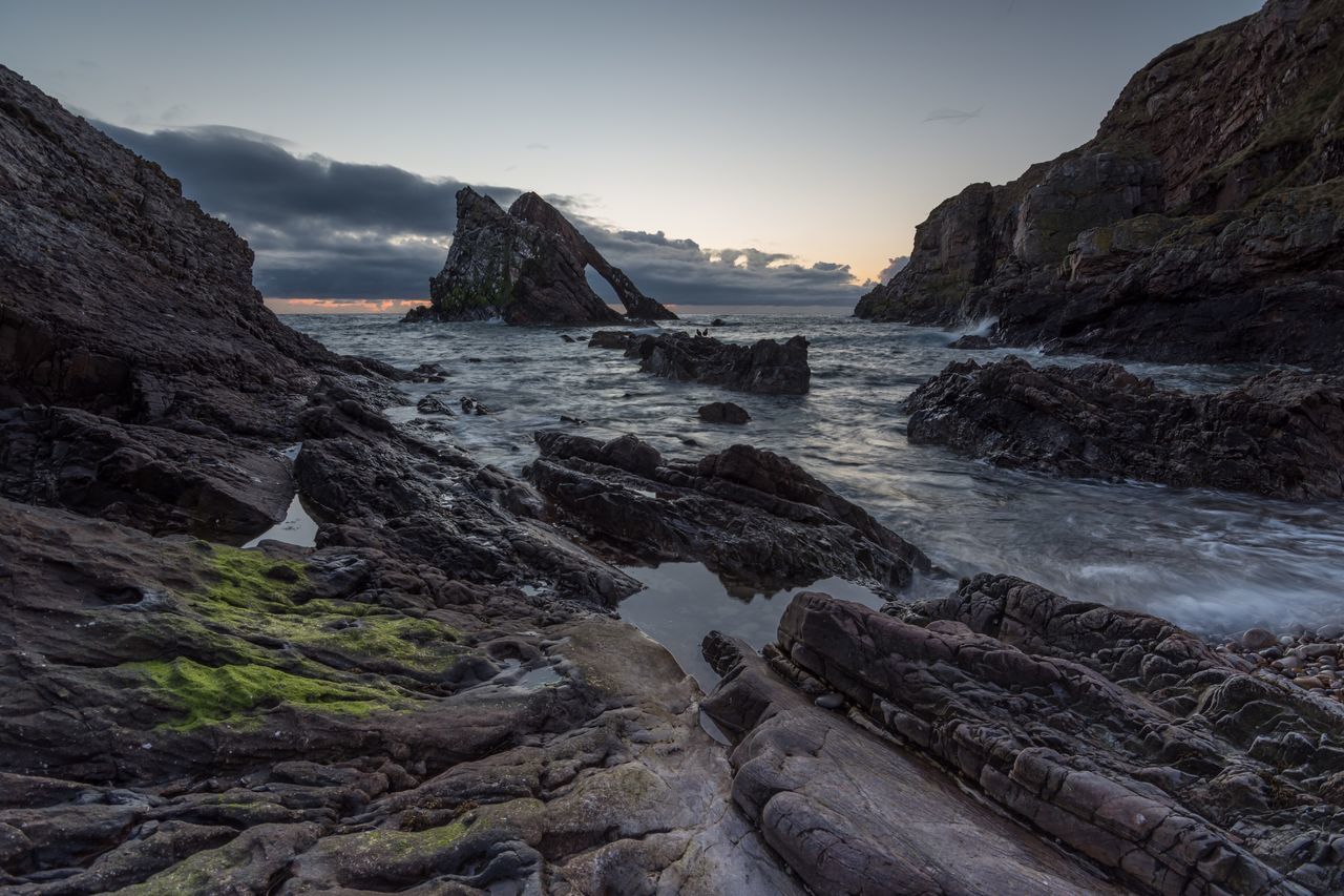 water, rock formation, rock - object, scenics, beauty in nature, sky, nature, cliff, tranquil scene, mountain, rock, tranquility, geology, sea, idyllic, physical geography, rocky mountains, motion, day, non-urban scene