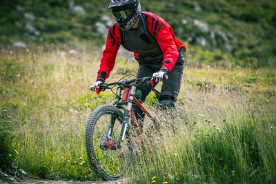 Man riding bicycle on field