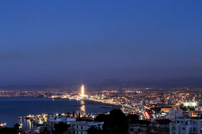 High angle view of illuminated buildings against sky at night