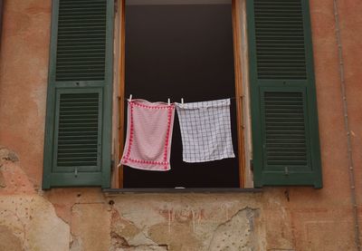 Low angle view of clothes drying against building