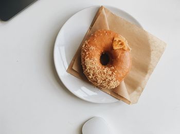 High angle view of a vegan donut dessert in a white plate on table