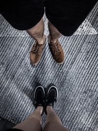 Low section of man standing on sidewalk