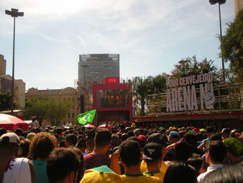 People on street in city against sky