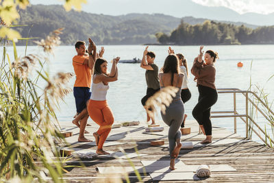 Female instructor teaching eagle pose during yoga class