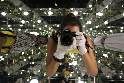 Portrait of woman photographing with camera