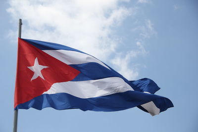 Low angle view of flag against blue sky