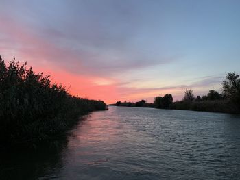 Scenic view of river against sky during sunset