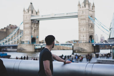 Woman sitting on bridge