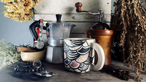 Coffee grinder, coffee cup on table, coffee cup on table...