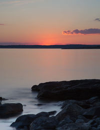 Scenic view of sea against romantic sky at sunset