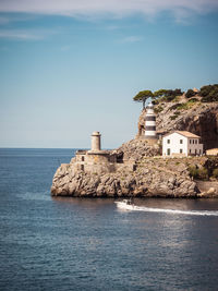 Building by sea against sky