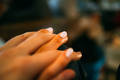 Cropped image of man and woman holding hands