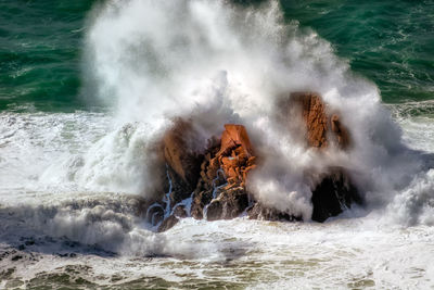 Waves splashing on rocks at shore