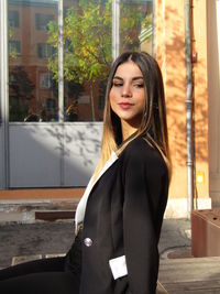Portrait of a beautiful young woman in city