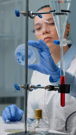 Young female scientist experimenting at lab