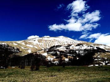 Low angle view of mountains against blue sky