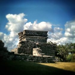 Low angle view of old ruin against cloudy sky