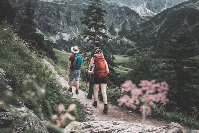 Rear view of women walking on mountain