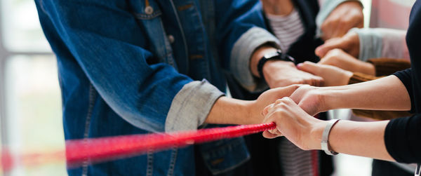 Rear view of people holding hands