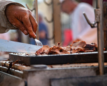 Midsection of man preparing food