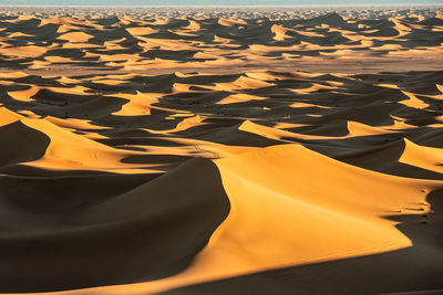 High angle view of sand dunes at sunset