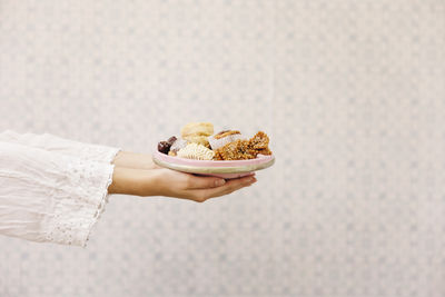 Cropped hand of woman holding food