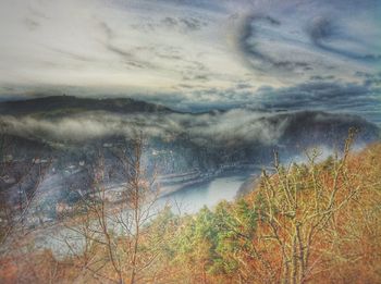 Scenic view of mountains against cloudy sky