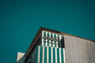 Low angle view of modern building against clear blue sky