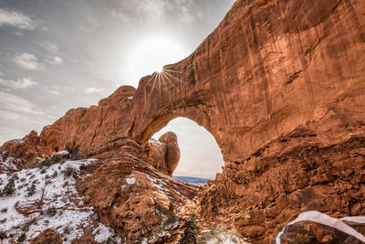 Rock formation against sky during winter