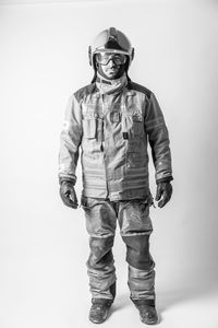 Portrait of young man standing against white background