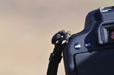 Close-up of toy camera on table against gray background