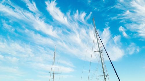 Low angle view of sailboat against blue sky
