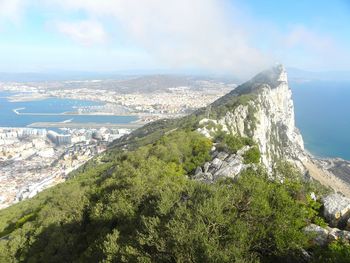 Scenic view of sea and mountains against sky