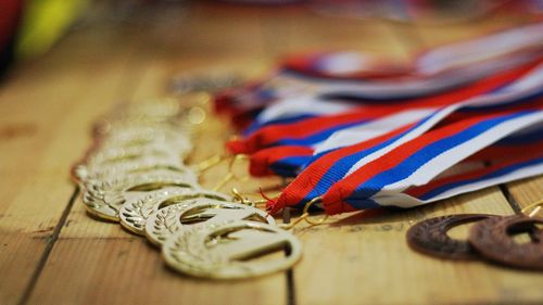 Close-up of medals on wooden table