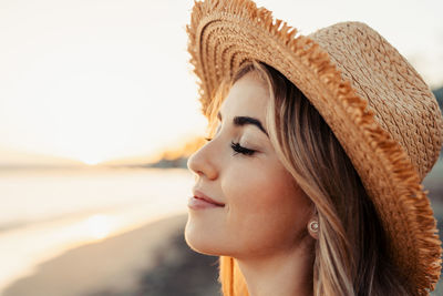 Close-up of young woman wearing hat