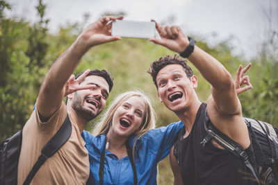 Portrait of smiling young woman using mobile phone